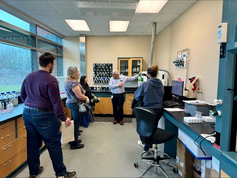 Group of people talking in a lab